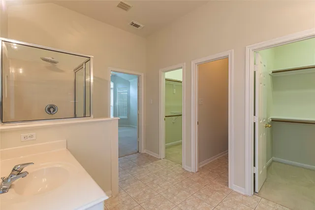 a porch with a table and chairs and couches with wooden fence