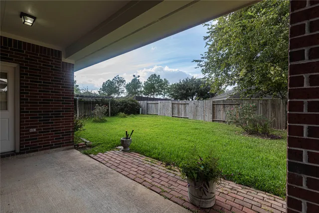 a view of a house with a yard and sitting area