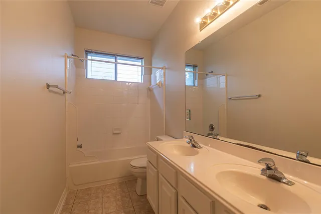 a bathroom with a double vanity sink and mirror with shower