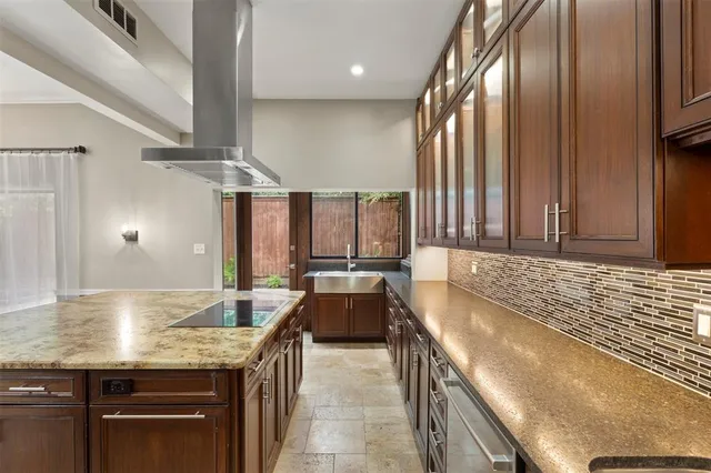 a bathroom with a granite countertop sink and bathtub