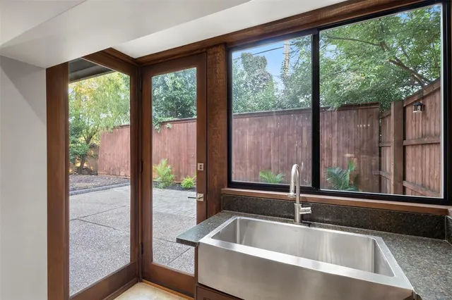 a kitchen with granite countertop white cabinets and black appliances