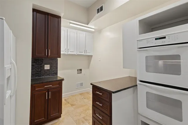 a hallway with a wooden floor and a ceiling fan