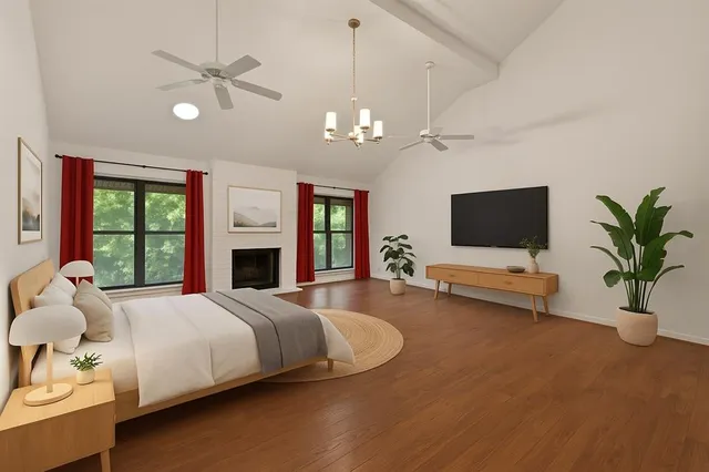 a bedroom with a bed window and a flat screen tv