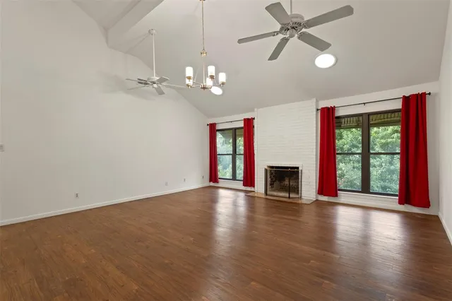 a view of staircase with wooden floor and a chandelier
