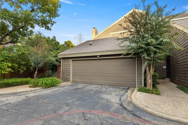 an aerial view of a house with garden space and street view