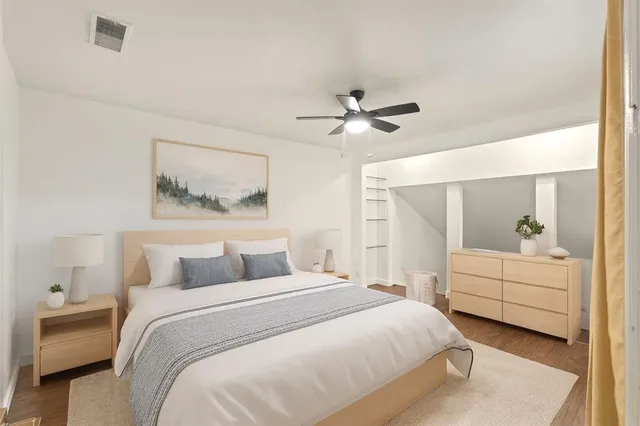 a bedroom with a white bed and a chandelier