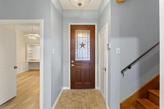 a view of a hallway with wooden floor and closet