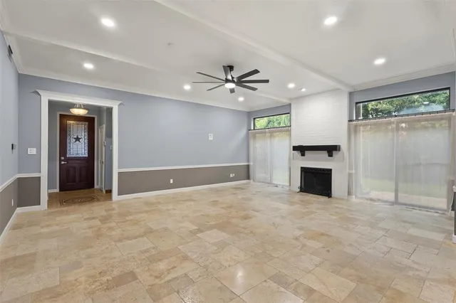 an empty room with fireplace and windows