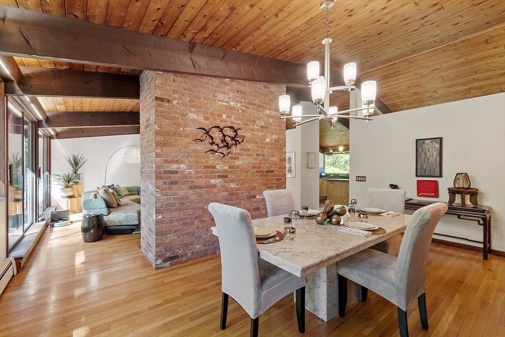 157 Carleton Road Carlisle, MA 01741 - Photo 13 of 42 a view of a dining room with furniture and wooden floor