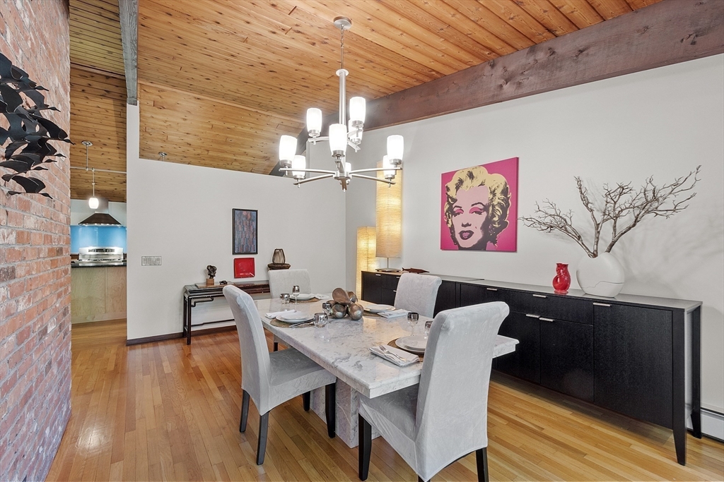 157 Carleton Road Carlisle, MA 01741 - Photo 14 of 42 a view of a dining room with furniture wooden floor and chandelier