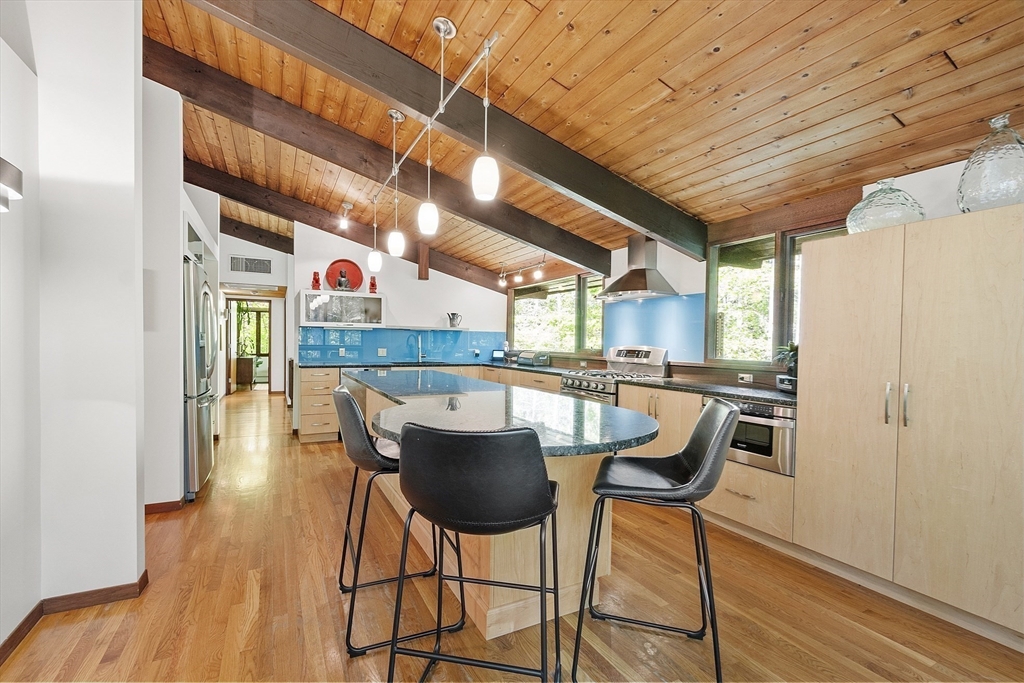 157 Carleton Road Carlisle, MA 01741 - Photo 15 of 42 a dining room with furniture and wooden floor