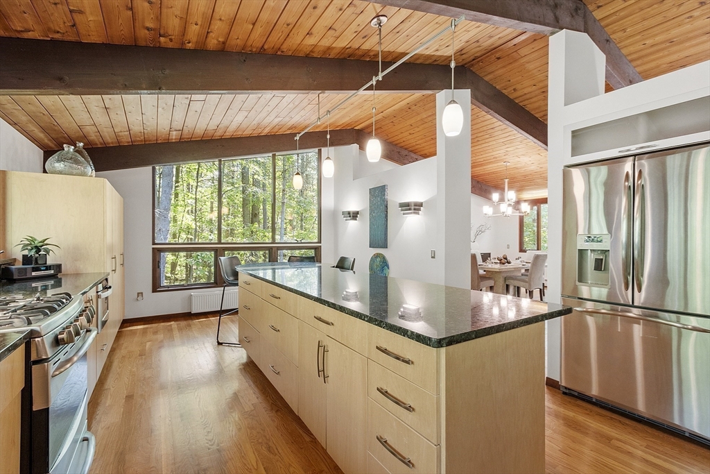 157 Carleton Road Carlisle, MA 01741 - Photo 17 of 42 a kitchen with stainless steel appliances granite countertop a stove a sink and a refrigerator