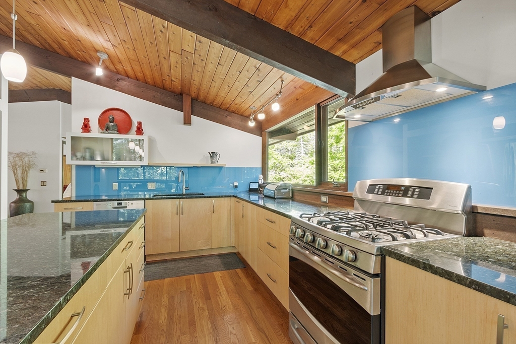 157 Carleton Road Carlisle, MA 01741 - Photo 18 of 42 a kitchen with stainless steel appliances granite countertop a stove a sink and a microwave