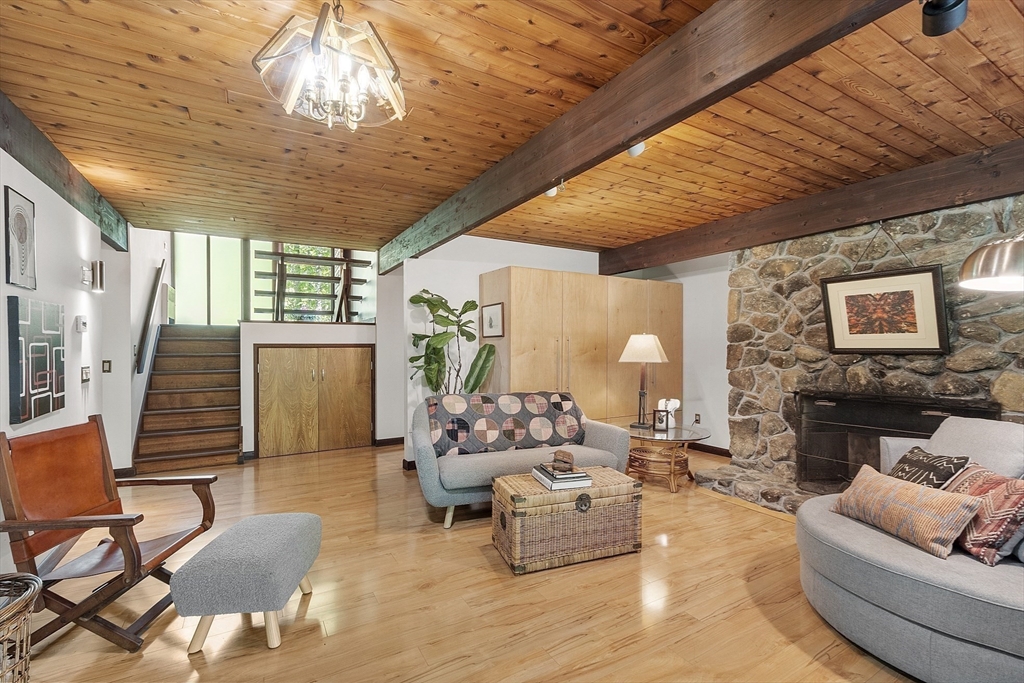 157 Carleton Road Carlisle, MA 01741 - Photo 26 of 42 a living room with furniture and a chandelier