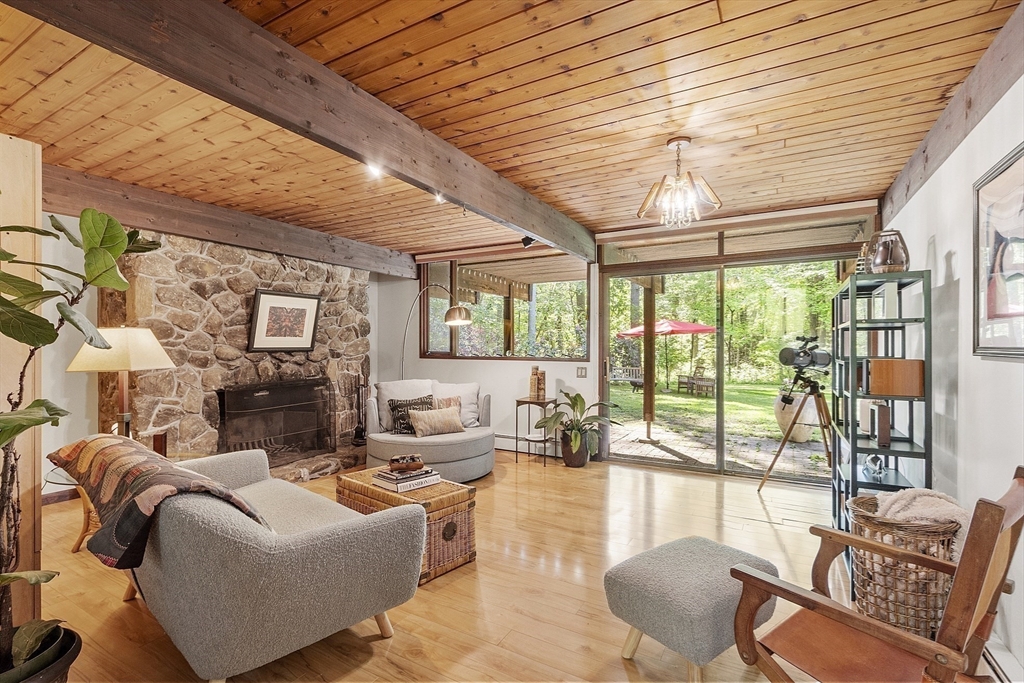 157 Carleton Road Carlisle, MA 01741 - Photo 27 of 42 a living room with furniture large windows and wooden floor