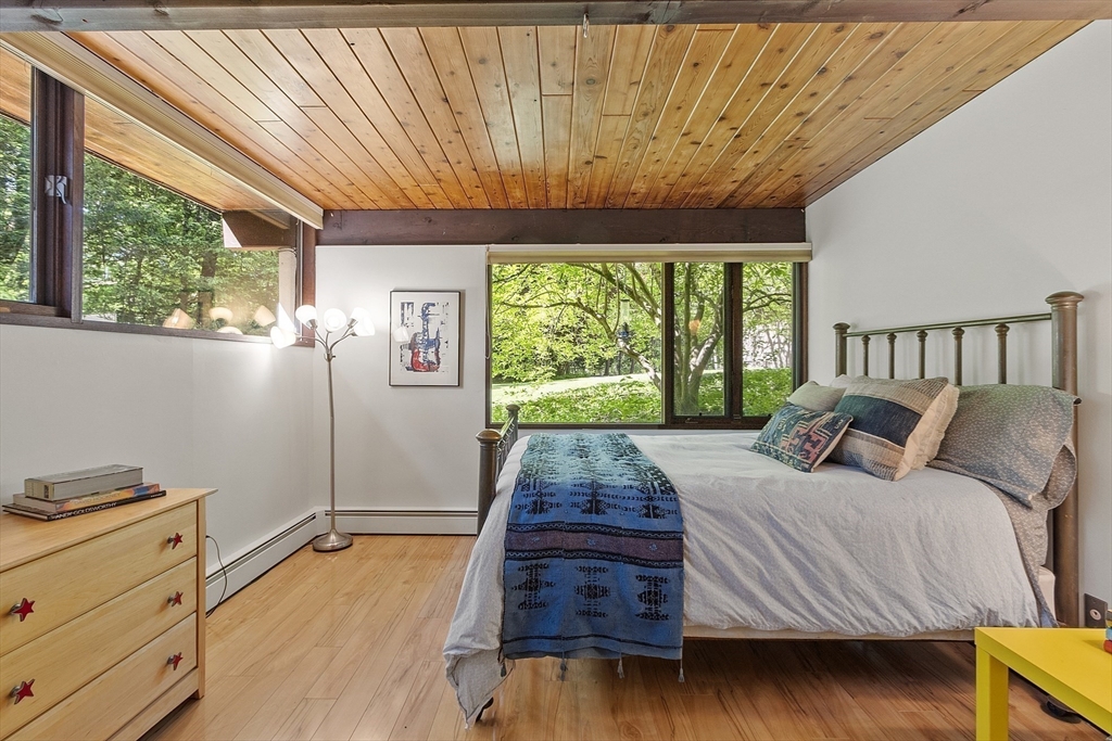 157 Carleton Road Carlisle, MA 01741 - Photo 30 of 42 a bed sitting in a bedroom next to a window