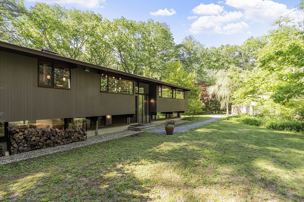 157 Carleton Road Carlisle, MA 01741 - Photo 32 of 42 a backyard of a house with lots of green space