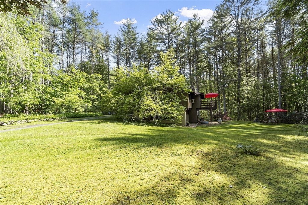 157 Carleton Road Carlisle, MA 01741 - Photo 40 of 42 a view of a fountain in front of a house with a big yard and fountain