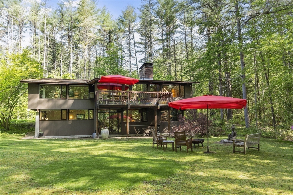 157 Carleton Road Carlisle, MA 01741 - Photo 42 of 42 a view of a cafe with a table and chairs under an umbrella
