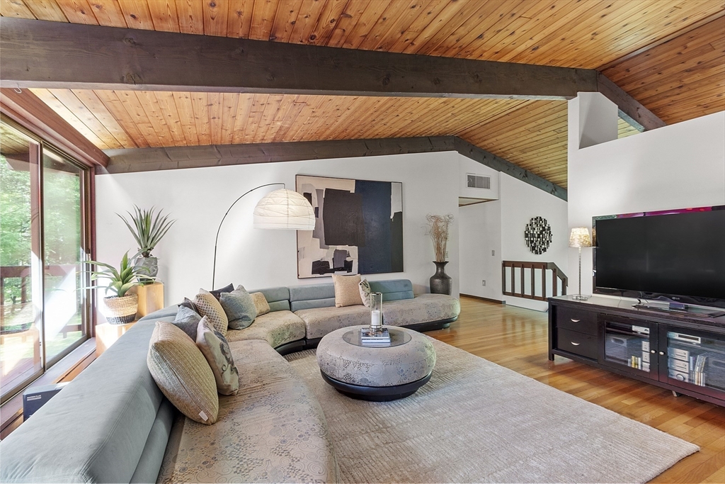 157 Carleton Road Carlisle, MA 01741 - Photo 7 of 42 a living room with furniture and a flat screen tv