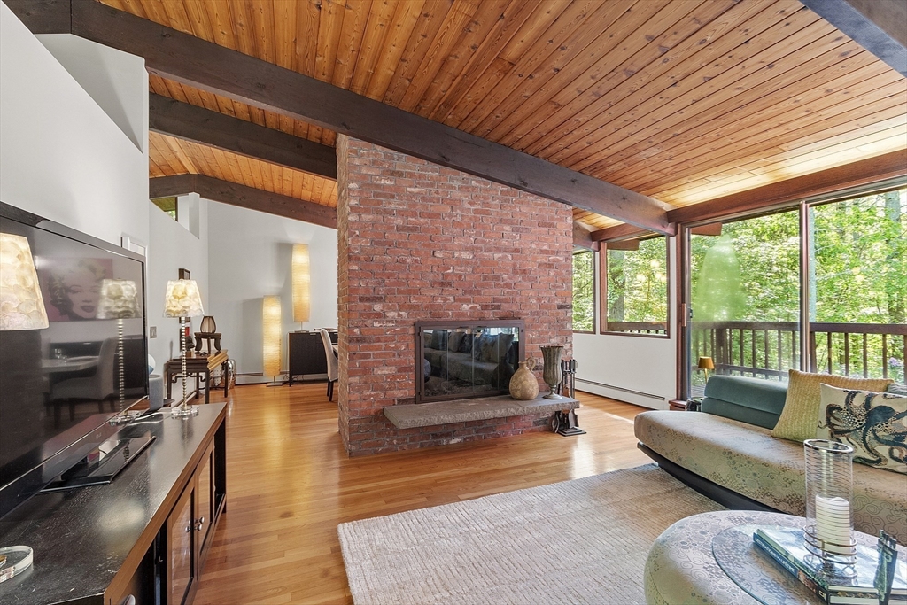 157 Carleton Road Carlisle, MA 01741 - Photo 10 of 42 a living room with furniture and a fireplace