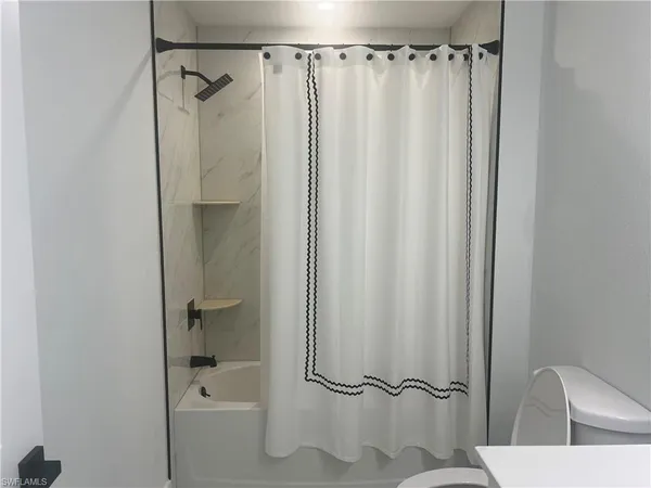 a bathroom with a shower and a tub