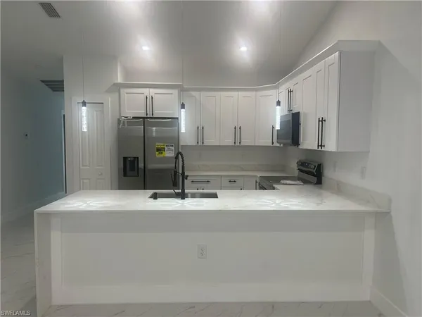 a kitchen with a sink and a refrigerator