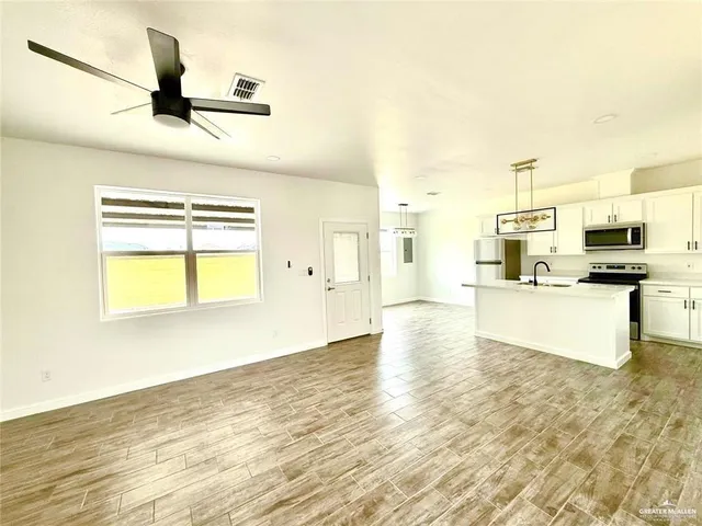 a view of kitchen and kitchen with microwave