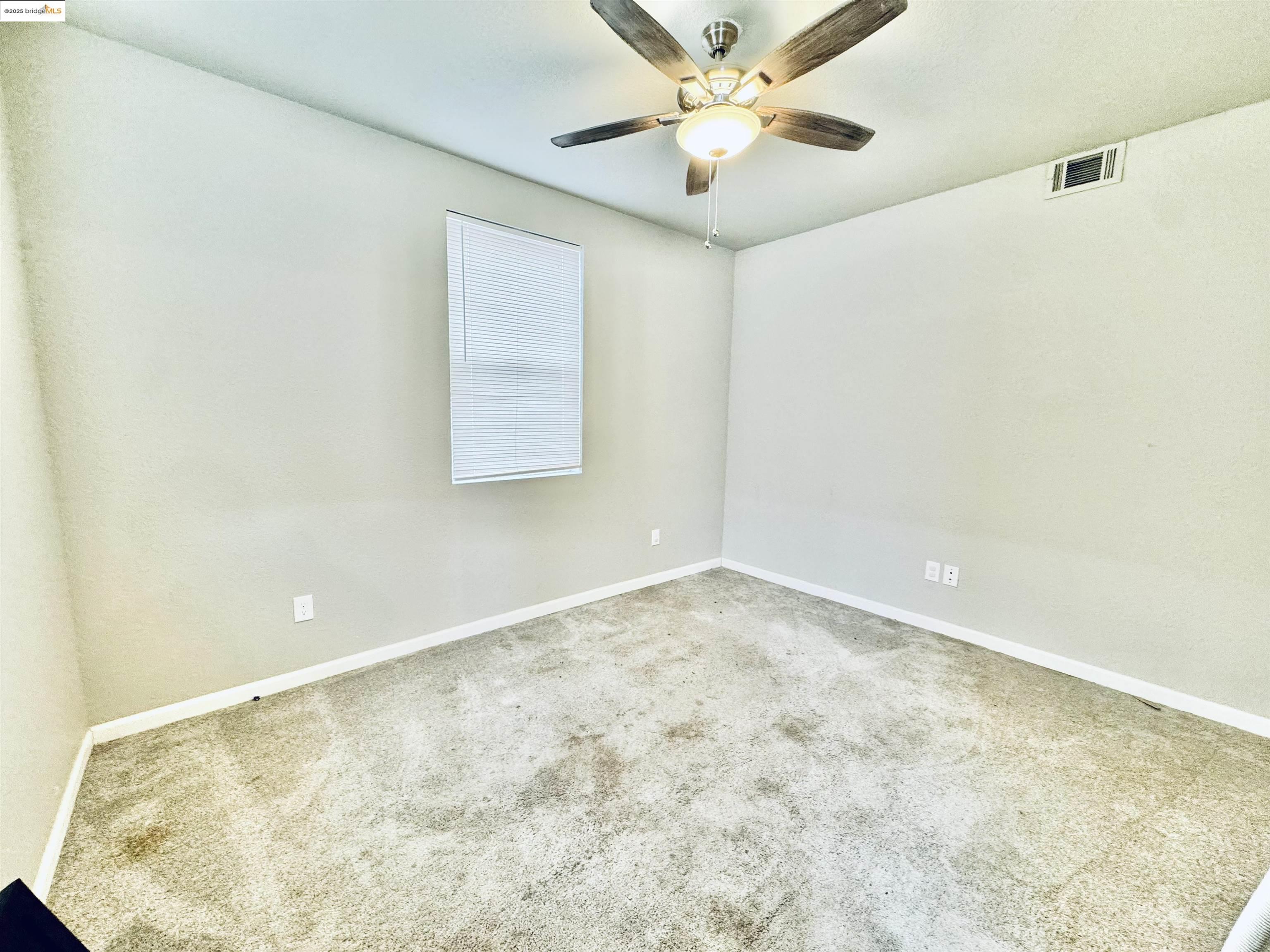 756 Rubier Way Rio Vista, CA 94571 - Photo 10 of 20 an empty room with a ceiling fan and a window