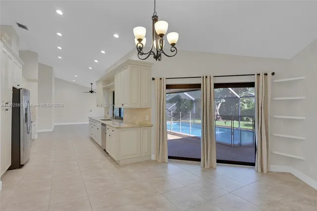 a view of a hallway with chandelier