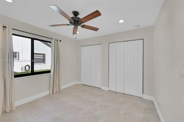a view of a livingroom with a ceiling fan and window