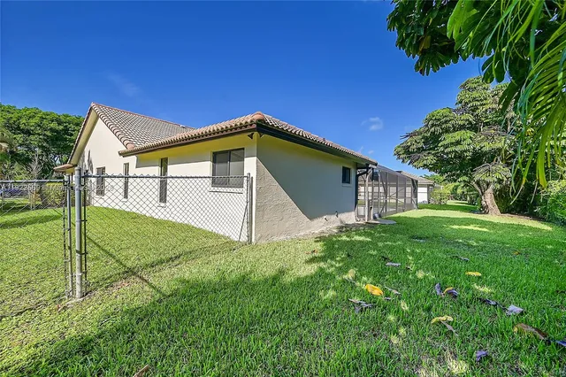 a yellow house with a yard