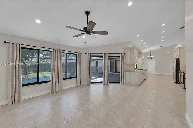 a view of an empty room with a fireplace and a large window