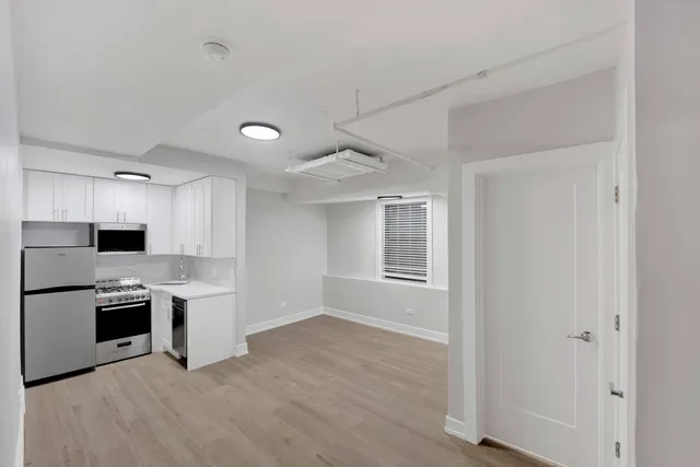 a kitchen with stainless steel appliances granite countertop a stove a sink and a refrigerator