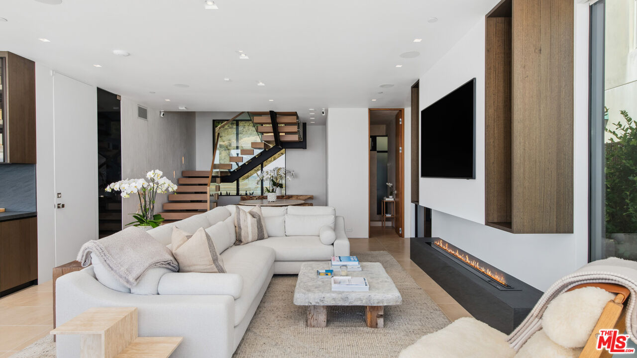 18954 Pacific Coast Highway Malibu, CA 90265 - Photo 11 of 70 a living room with furniture and a flat screen tv