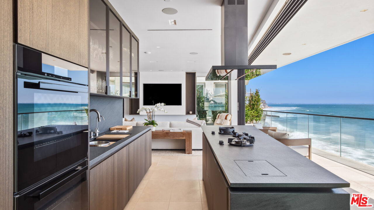 18954 Pacific Coast Highway Malibu, CA 90265 - Photo 14 of 70 a kitchen with stainless steel appliances a sink stove and wooden floor