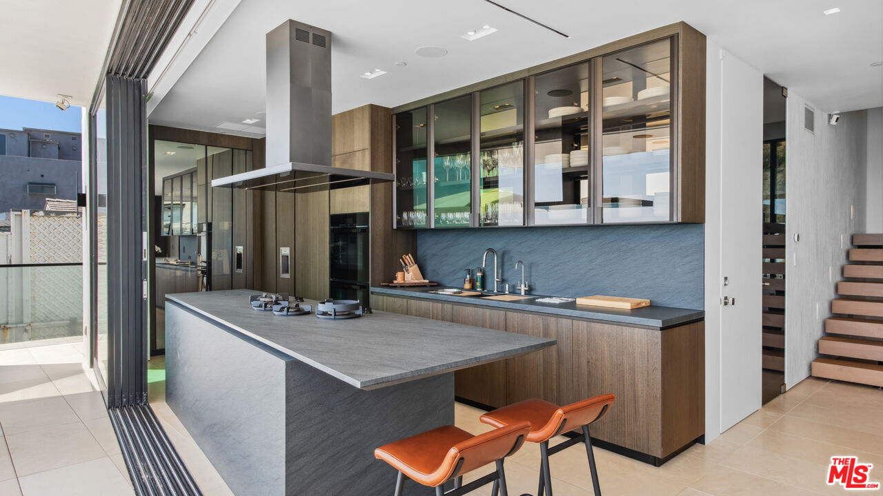 18954 Pacific Coast Highway Malibu, CA 90265 - Photo 15 of 70 a kitchen with stainless steel appliances granite countertop a sink and a refrigerator