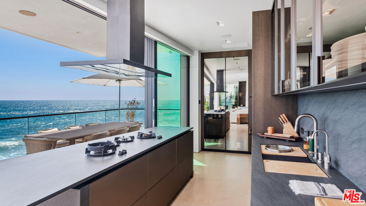 18954 Pacific Coast Highway Malibu, CA 90265 - Photo 16 of 70 a kitchen with stainless steel appliances granite countertop a stove and a refrigerator