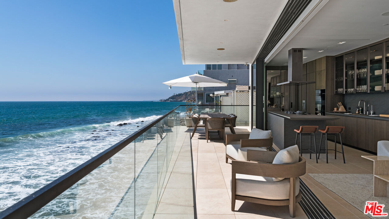 18954 Pacific Coast Highway Malibu, CA 90265 - Photo 17 of 70 a view of a patio with chairs and potted plants