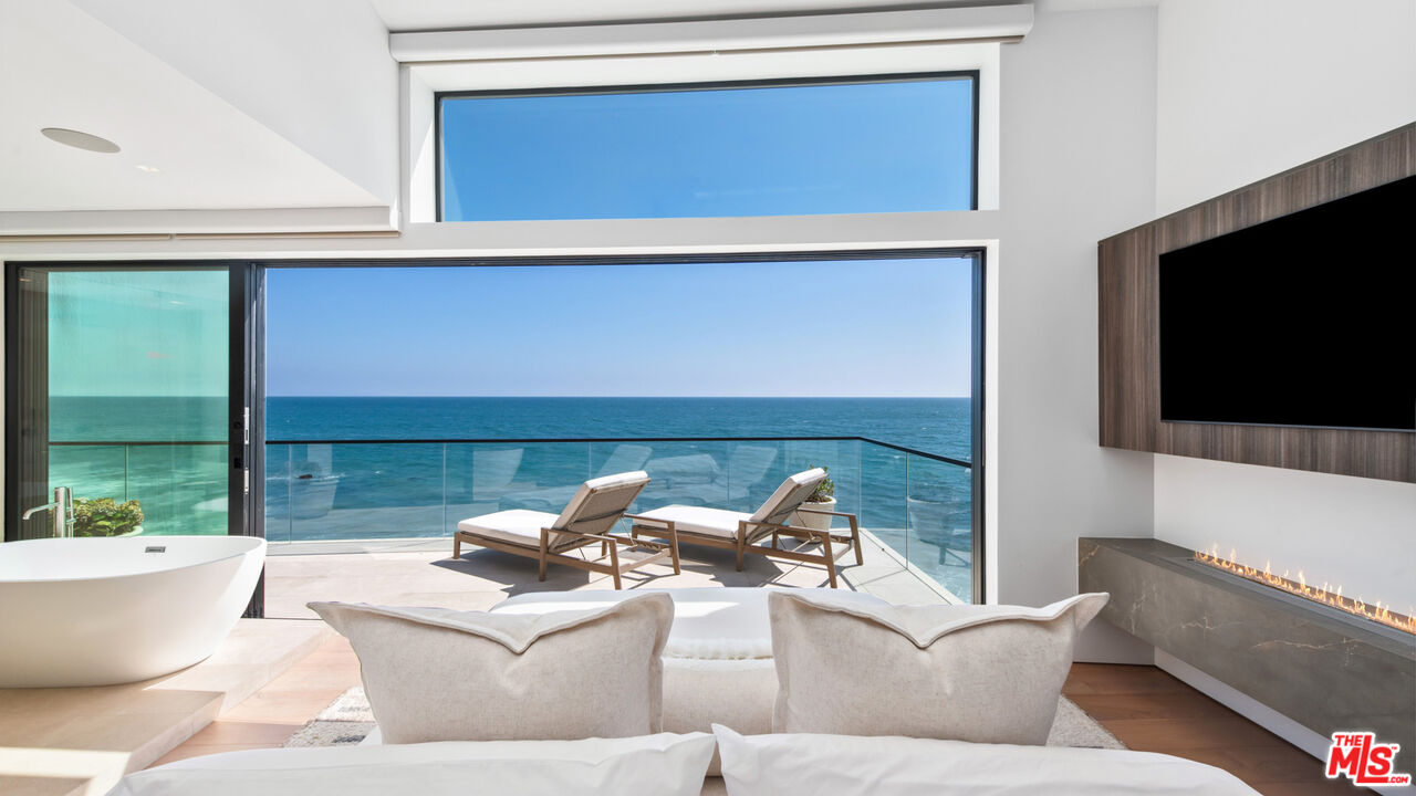 18954 Pacific Coast Highway Malibu, CA 90265 - Photo 22 of 70 a living room with furniture and a flat screen tv