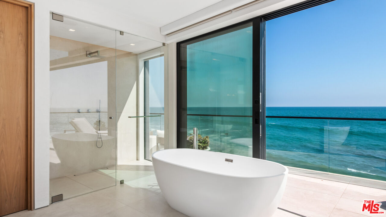 18954 Pacific Coast Highway Malibu, CA 90265 - Photo 28 of 70 a bathroom with a white tub and shower