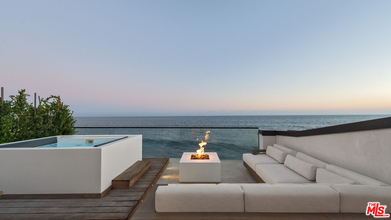 18954 Pacific Coast Highway Malibu, CA 90265 - Photo 53 of 70 a living room with furniture and a potted plant