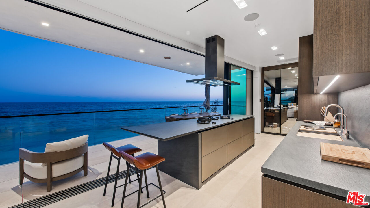 18954 Pacific Coast Highway Malibu, CA 90265 - Photo 57 of 70 a kitchen with stainless steel appliances granite countertop a sink a stove and a refrigerator