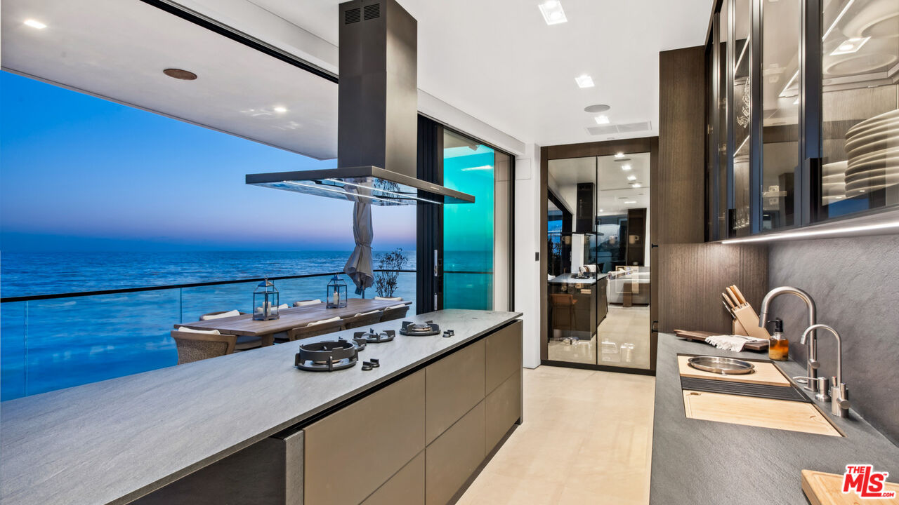 18954 Pacific Coast Highway Malibu, CA 90265 - Photo 59 of 70 a kitchen with stainless steel appliances granite countertop a sink a stove and a wooden floors