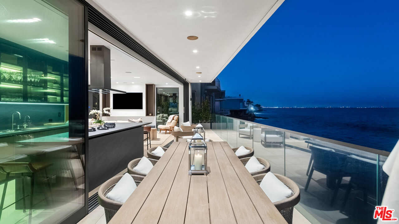 18954 Pacific Coast Highway Malibu, CA 90265 - Photo 63 of 70 a view of a patio with table and chairs with wooden floor and fence