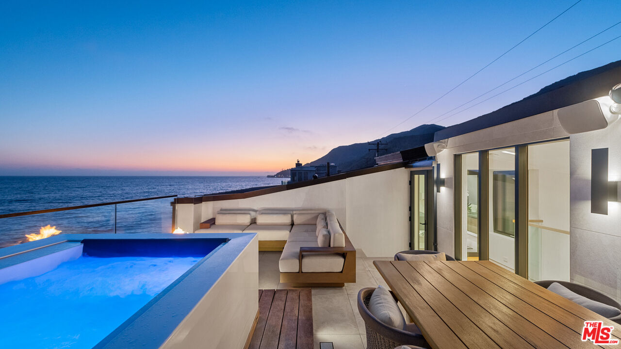 18954 Pacific Coast Highway Malibu, CA 90265 - Photo 70 of 70 a view of a balcony with wooden floor and iron fence
