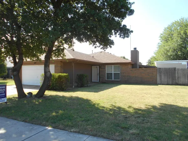 a house view with a sitting space and garden