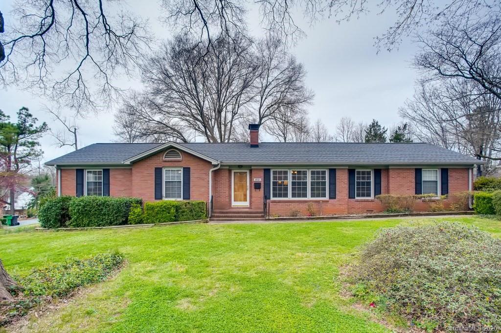 4921 Cheviot Road Charlotte, NC 28269 - Photo 1 of 28 a front view of a house with a yard and trees