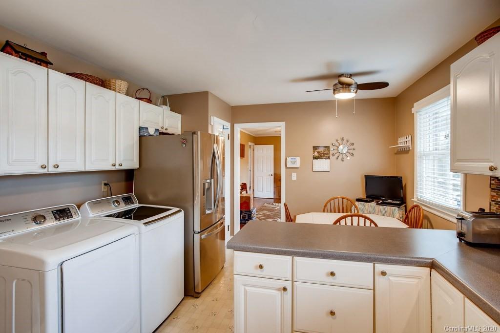 4921 Cheviot Road Charlotte, NC 28269 - Photo 11 of 28 a kitchen with a sink a refrigerator and cabinets