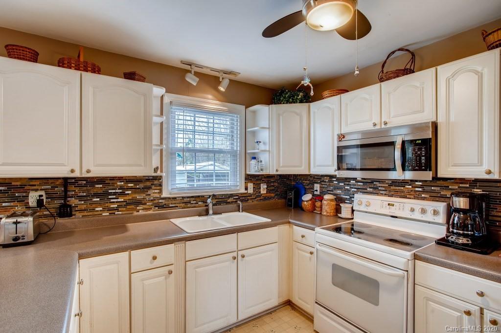 4921 Cheviot Road Charlotte, NC 28269 - Photo 12 of 28 a kitchen with appliances a sink and cabinets